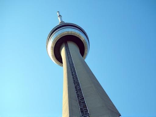 Close-up architectural detail of the CN Tower against a blue sky